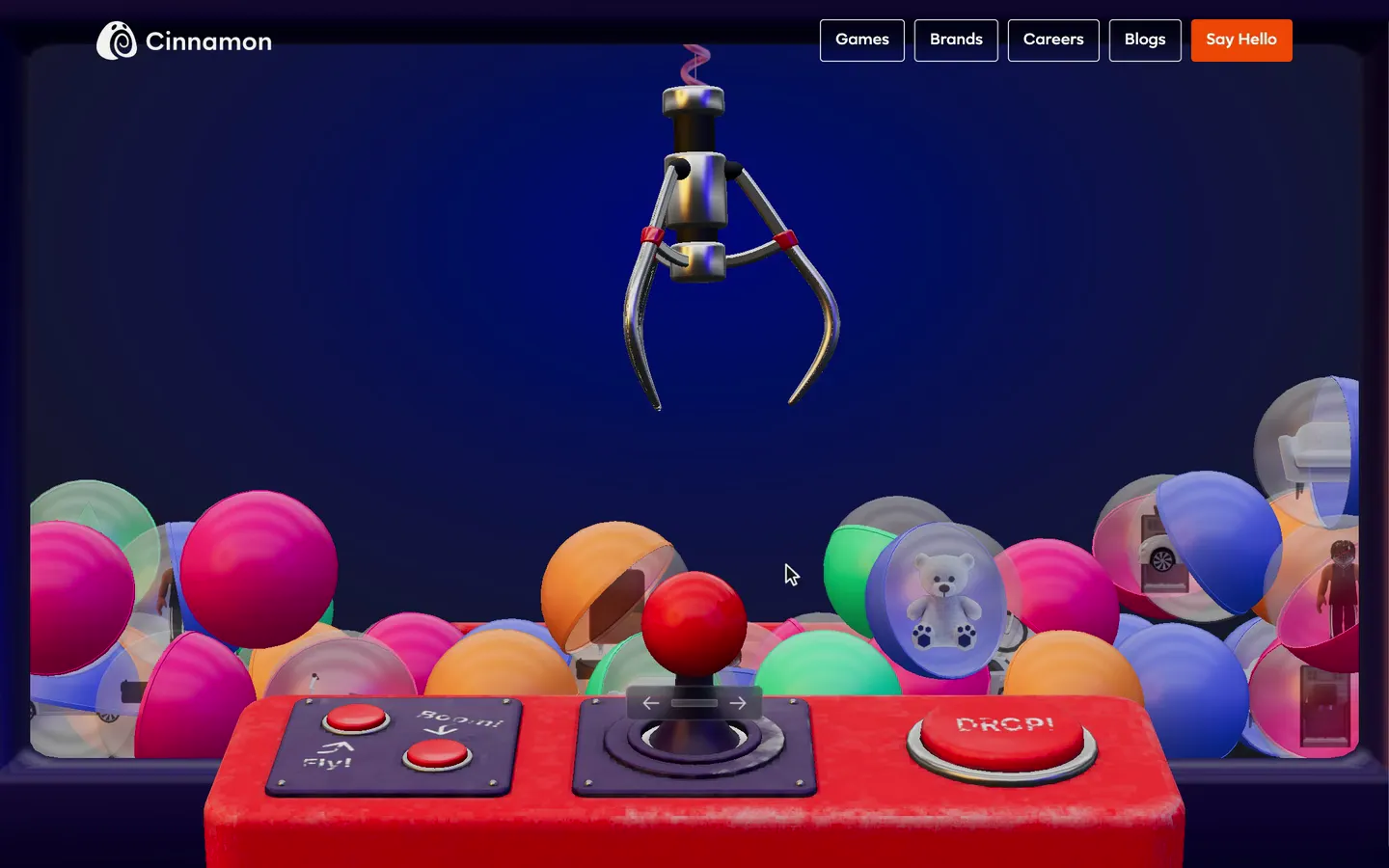 A cursor swings the arcade joystick right, left and right, sweeping the chrome claw across a machine full of colourful capsules, then clicks Drop; the claw plunges into the pile and lifts an orange capsule.