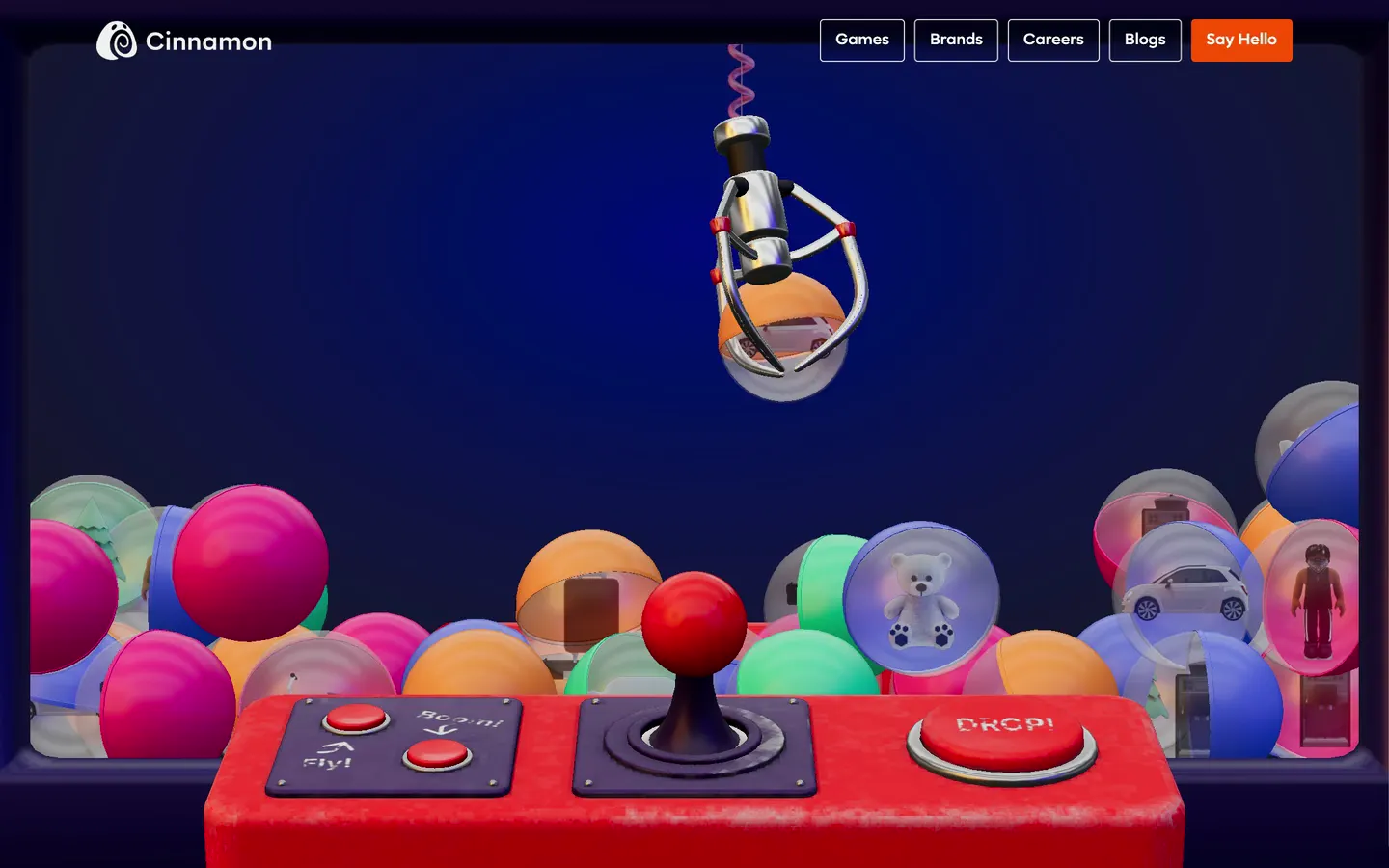 The claw drops the orange capsule into the chute, the page scrolls on, and the capsule pops out of the machine and splits open around a white toy Fiat 500 as Enter the World of Cinnamon pops in.